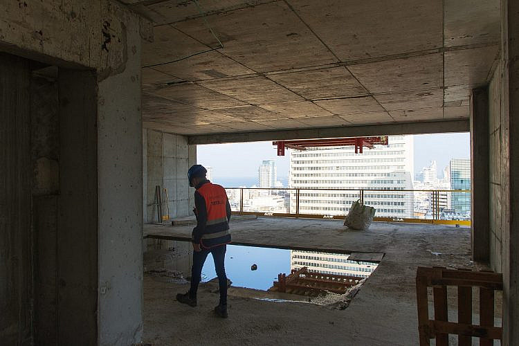מי יבנה יבנה בית. פועל באתר בנייה בתל אביב (צילום: Bar Levixr/שאטרסטוק)