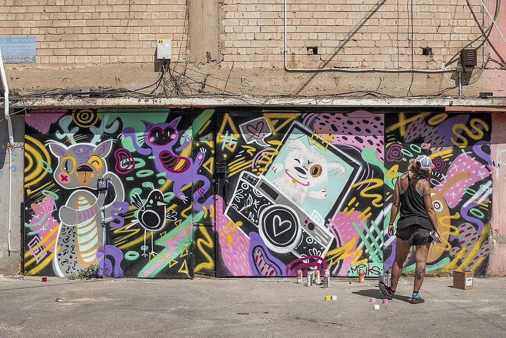 אמנית הגרפיטי מינקס בכניסה לסטודיו (צילום: הלה עמנואל)